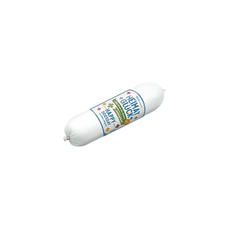 HEIMATGLÜCK Happy Dogsday, 300 g – offizielles REiCO Produktmotiv, freigestellt auf transparentem Hintergrund.